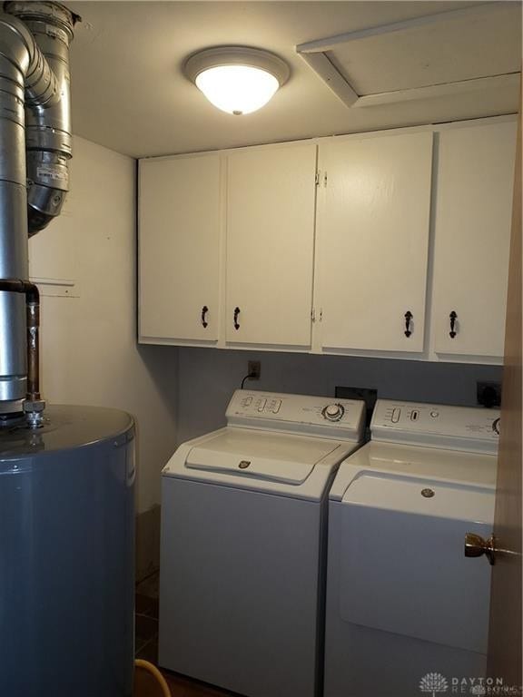 laundry area with cabinet space, washing machine and dryer, and water heater