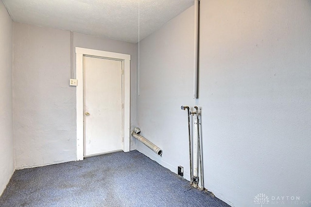 interior space with laundry area and a textured ceiling