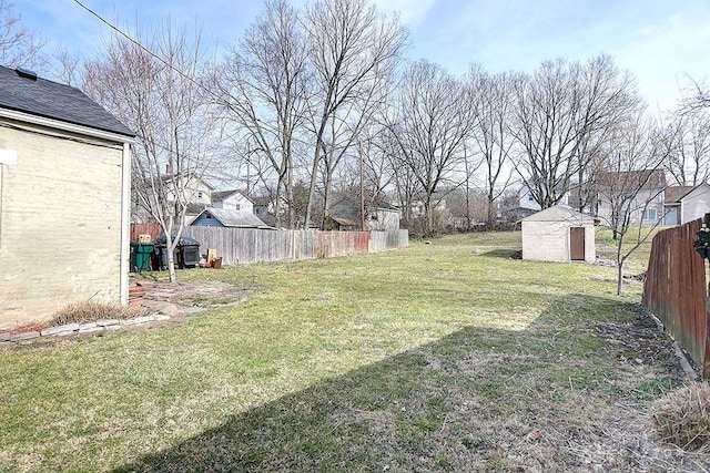 view of yard with a storage unit, an outdoor structure, and fence