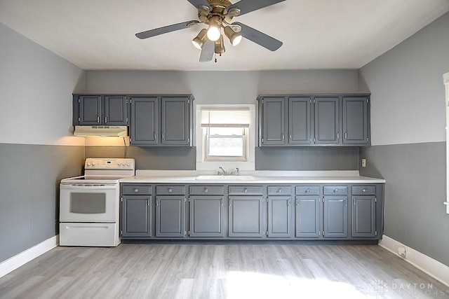 kitchen with under cabinet range hood, ceiling fan, light countertops, and electric stove