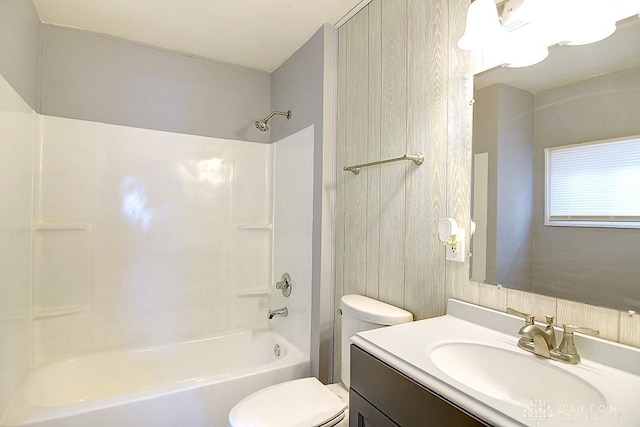 bathroom with toilet, vanity, and shower / tub combination