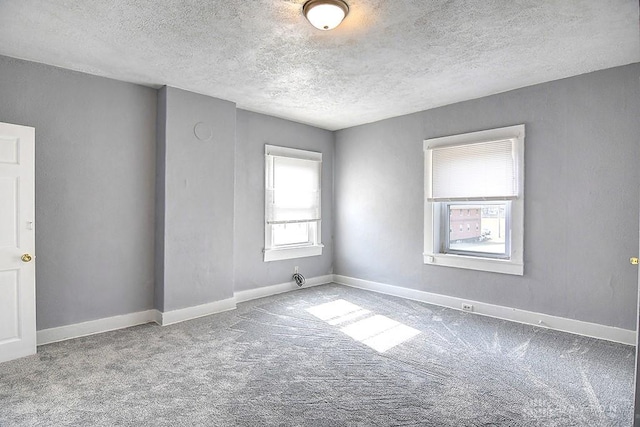 unfurnished room with baseboards and carpet