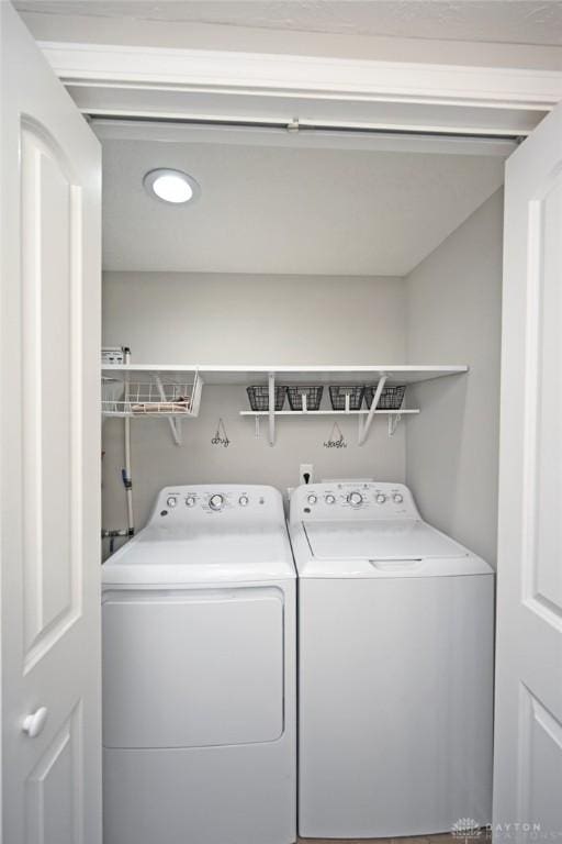 laundry area with laundry area and washer and clothes dryer