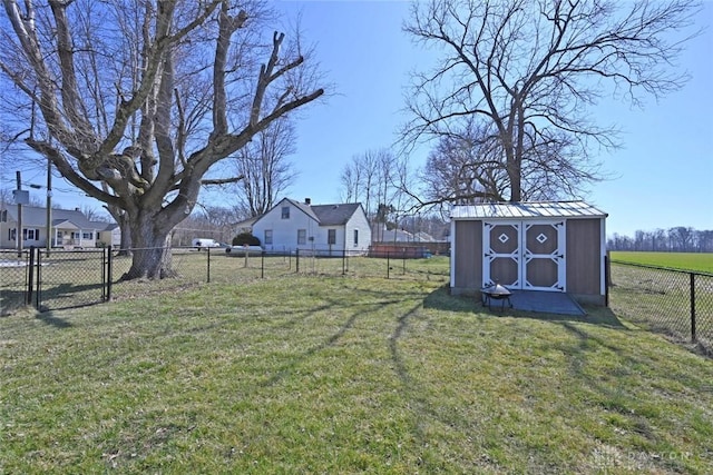 view of yard featuring a storage shed, a fenced backyard, and an outdoor structure