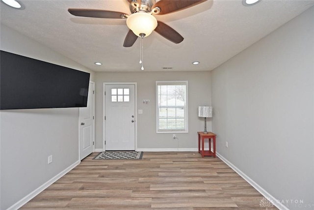 entryway with visible vents, baseboards, light wood-type flooring, recessed lighting, and a ceiling fan