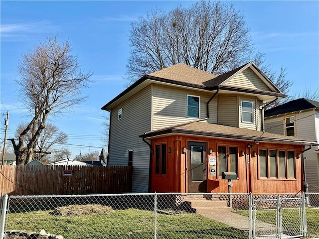 view of front of house with a gate, covered porch, a fenced front yard, and roof with shingles