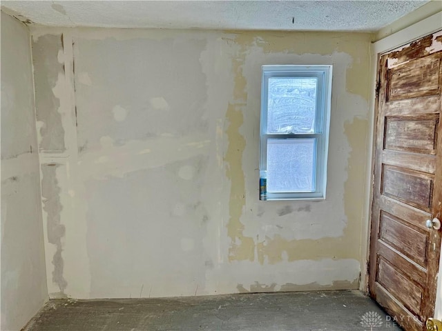 empty room featuring a textured ceiling