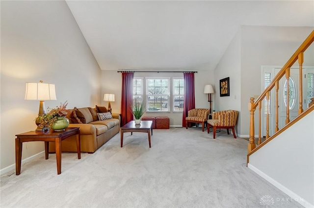 living room with stairway, baseboards, light colored carpet, and high vaulted ceiling