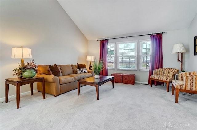 living room featuring light colored carpet, baseboards, and high vaulted ceiling