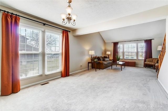 interior space featuring visible vents, lofted ceiling, carpet, an inviting chandelier, and baseboards