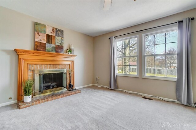 unfurnished living room featuring visible vents, baseboards, carpet, and a brick fireplace