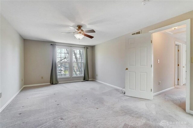 unfurnished room with visible vents, baseboards, a ceiling fan, and carpet floors