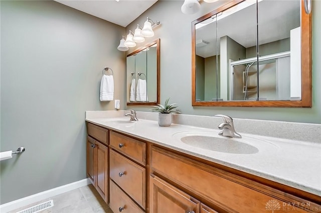 full bath featuring tile patterned floors, visible vents, double vanity, and a sink