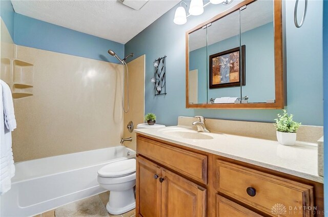 full bathroom with vanity,  shower combination, tile patterned flooring, a textured ceiling, and toilet