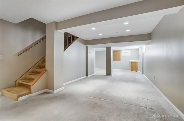 basement with stairway, recessed lighting, and baseboards