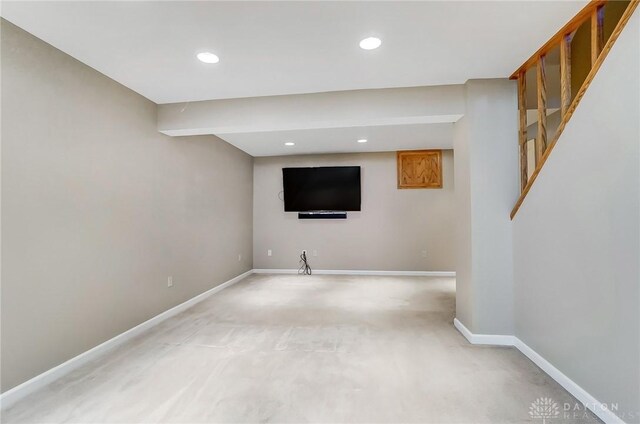 finished below grade area with recessed lighting, light colored carpet, and baseboards