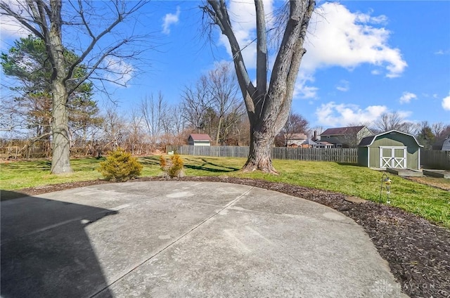 view of patio / terrace with fence private yard, an outdoor structure, and a shed