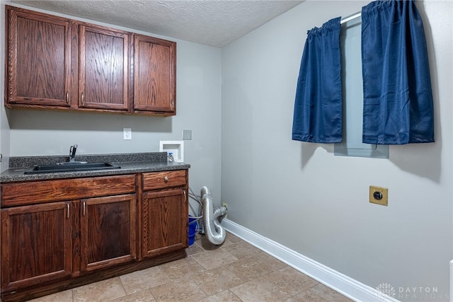 interior space with vanity, baseboards, and a textured ceiling