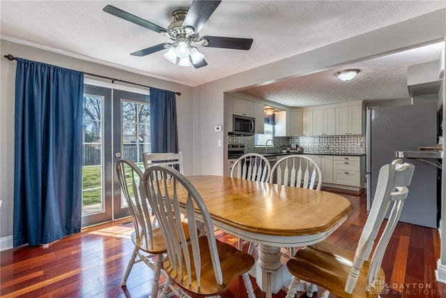 dining room featuring a textured ceiling, ceiling fan, and wood-type flooring