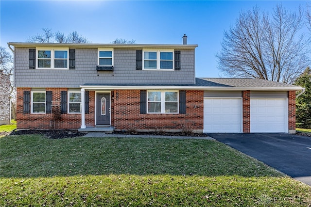 view of front facade featuring a front lawn, brick siding, a garage, and driveway