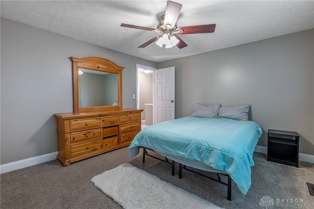 carpeted bedroom featuring baseboards, a textured ceiling, and ceiling fan