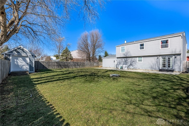 view of yard featuring a patio, an outdoor structure, a storage shed, and a fenced backyard