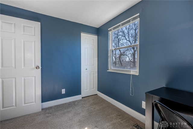 carpeted bedroom featuring visible vents, baseboards, and a closet