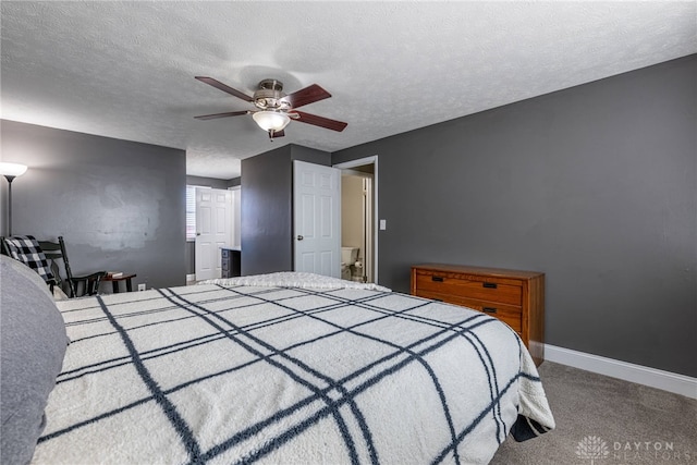 carpeted bedroom with ceiling fan, baseboards, and a textured ceiling