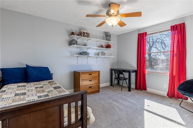 carpeted bedroom with ceiling fan and baseboards