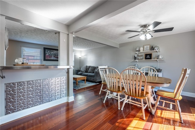 dining area with ceiling fan, baseboards, wood-type flooring, and a textured ceiling