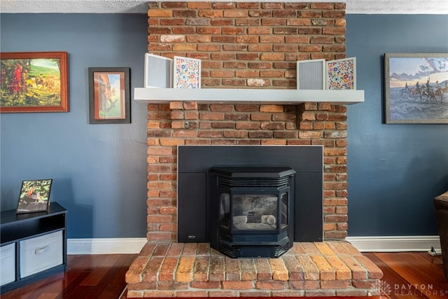 room details featuring wood finished floors, baseboards, and a textured ceiling