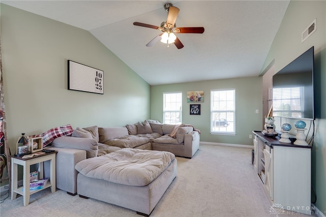 living room with a ceiling fan, baseboards, visible vents, vaulted ceiling, and light carpet