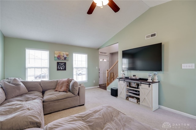 living area with stairs, ceiling fan, visible vents, and light carpet