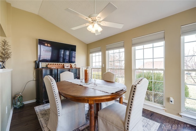 dining area featuring a ceiling fan, vaulted ceiling, wood finished floors, and baseboards