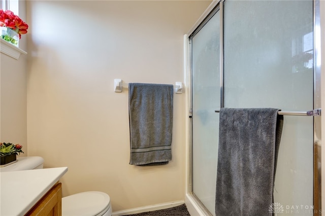 full bathroom with a shower stall, toilet, and vanity