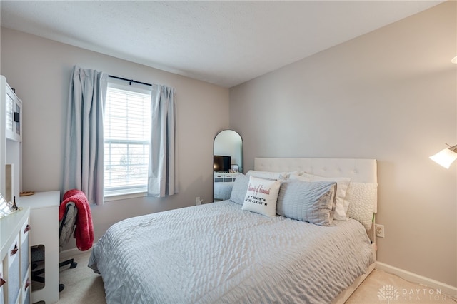 carpeted bedroom featuring baseboards