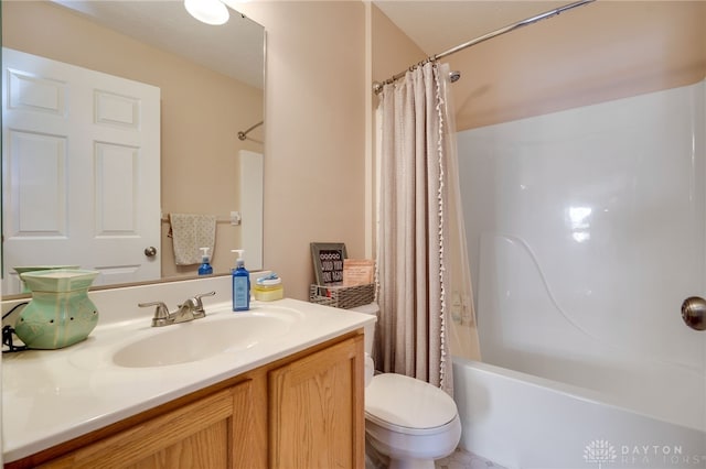 full bathroom with vanity, shower / tub combo, and toilet