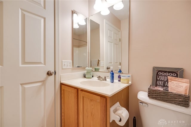 bathroom featuring toilet and vanity