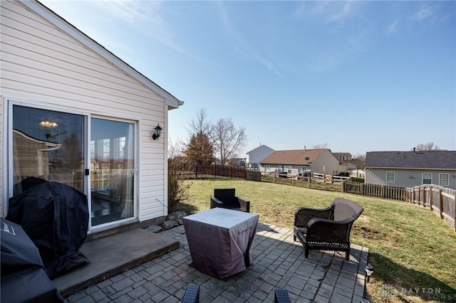 view of patio featuring grilling area, a residential view, and a fenced backyard