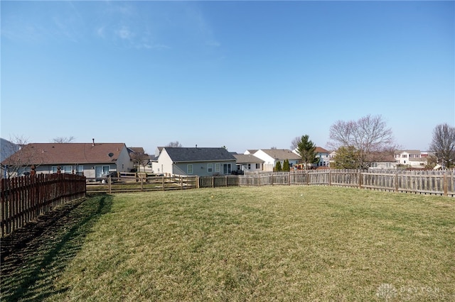 view of yard featuring a residential view and a fenced backyard