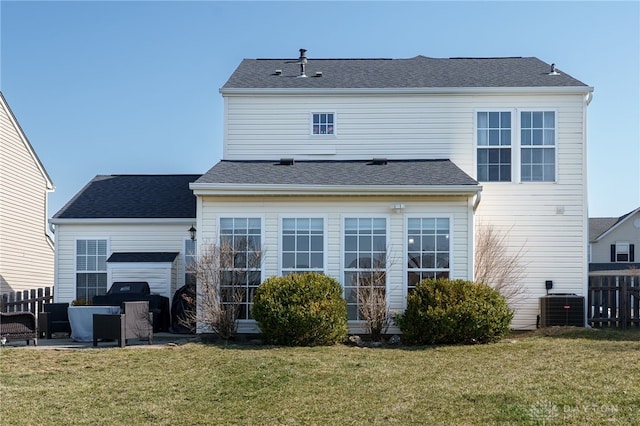 rear view of property with a patio area, a lawn, fence, and central AC