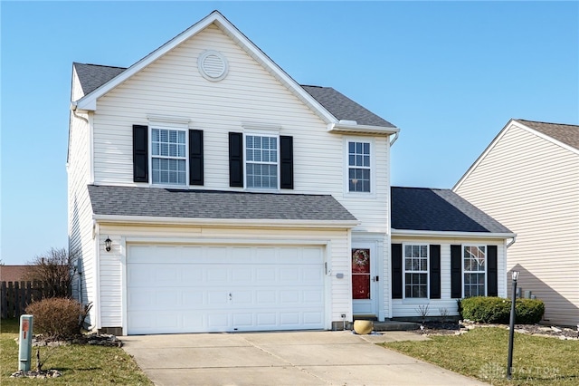 traditional-style home with an attached garage, roof with shingles, and driveway