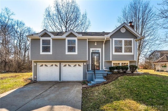 bi-level home featuring a garage, a front lawn, a chimney, and driveway