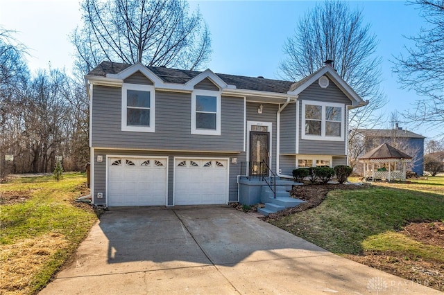 bi-level home featuring a front yard, concrete driveway, and an attached garage