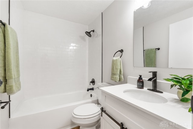 bathroom featuring washtub / shower combination, toilet, vanity, and a textured ceiling