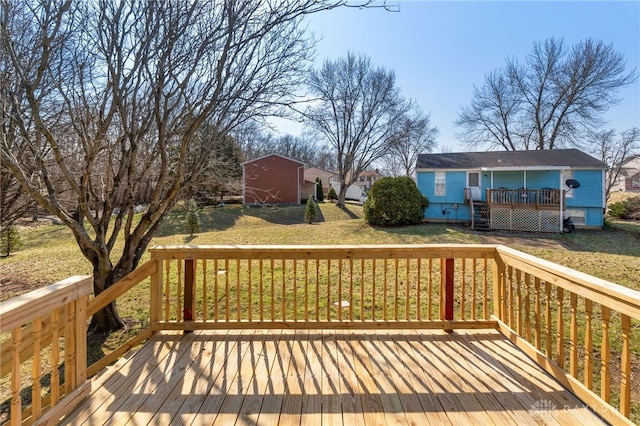 deck with an outbuilding and a lawn