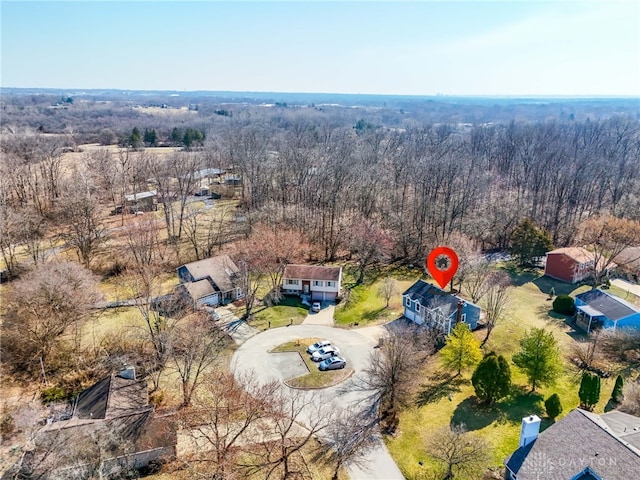 bird's eye view featuring a wooded view