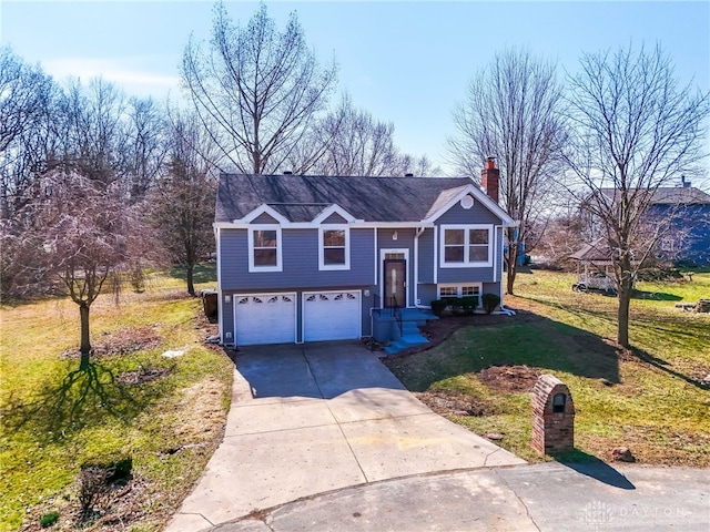 bi-level home with a front lawn, concrete driveway, and an attached garage