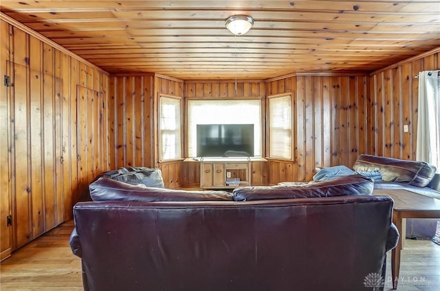 living area featuring wooden ceiling, light wood-style flooring, and wooden walls