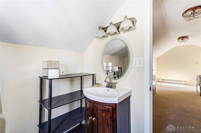 bathroom with lofted ceiling, baseboard heating, and vanity